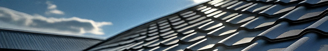 Modern dark grey metal roof with clean lines and premium finish, photographed in bright daylight, ideal for roof replacement services in Brisbane.